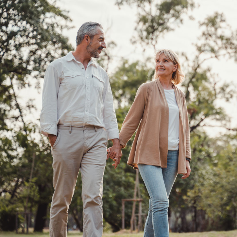 Happy landlords walking through a park